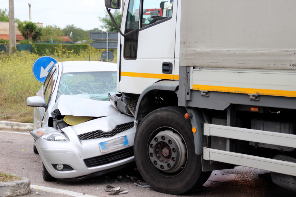 image of a car and truck following a collision. Truck Accidents 