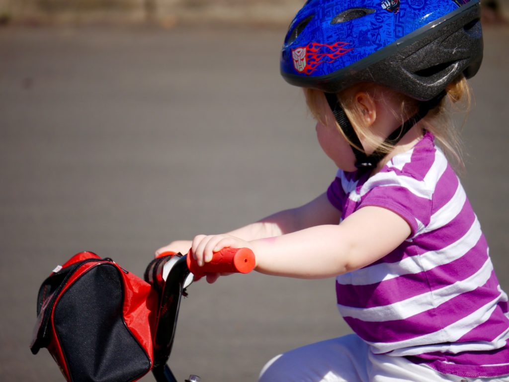 Small child riding a bike - How to Pick Child Bike Helmet