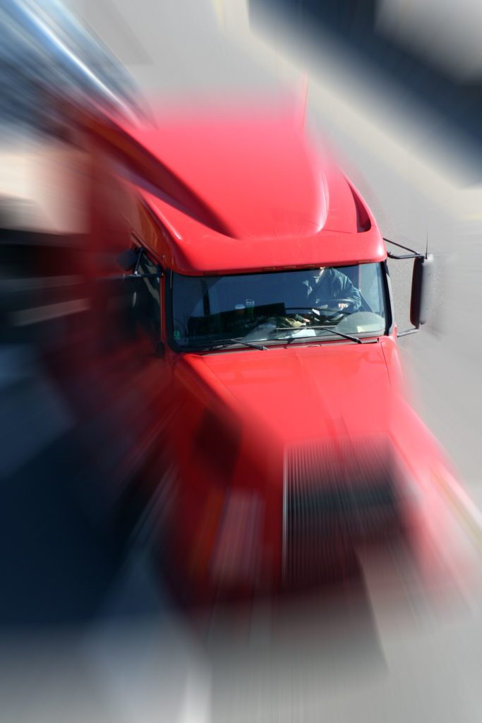 Speeding red semi-tractor truck | Kern County Accident Injury Attorney